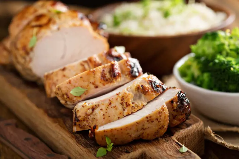 Image of sliced meat surrounded by other foods