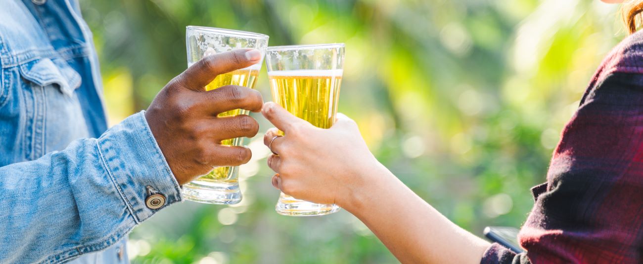 Kinnegar Brewing - Banner Image People Holding Drinks to Cheers