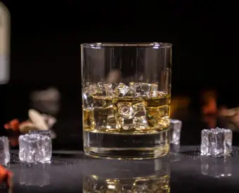 Glass of whiskey with ice