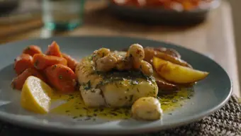 Range of seafood on a plate with table setting in background
