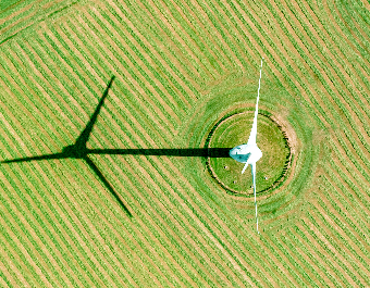 Aerial view of wind turbine in plowed field